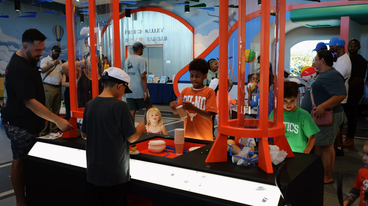 Visitors experimenting together at a hands-on aviation exhibit.