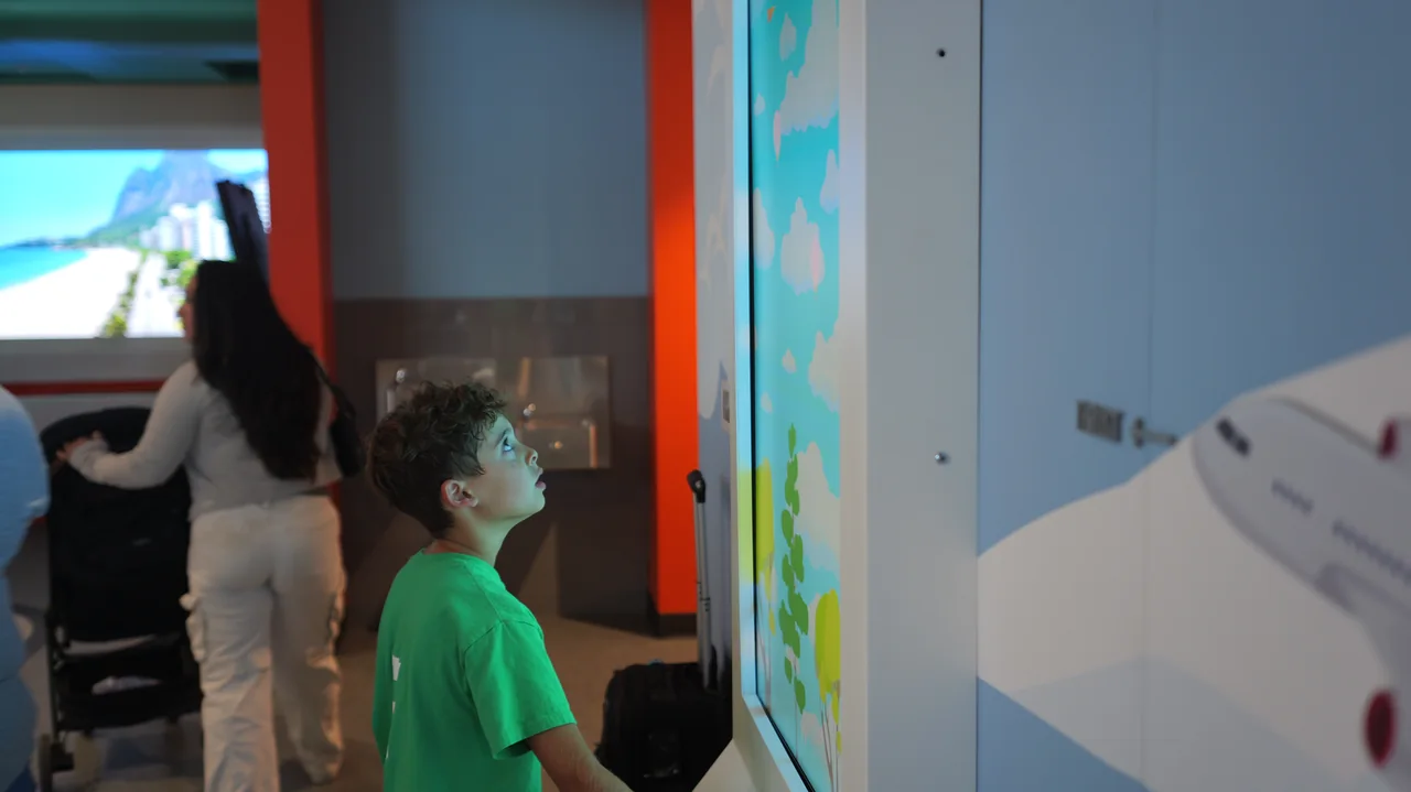 A child interacting with a colorful digital display.