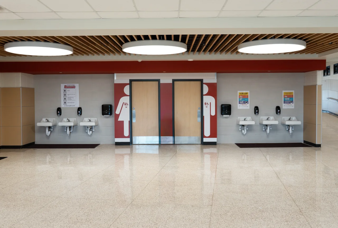 A timber ceiling and circular lights mark the gym entrance.