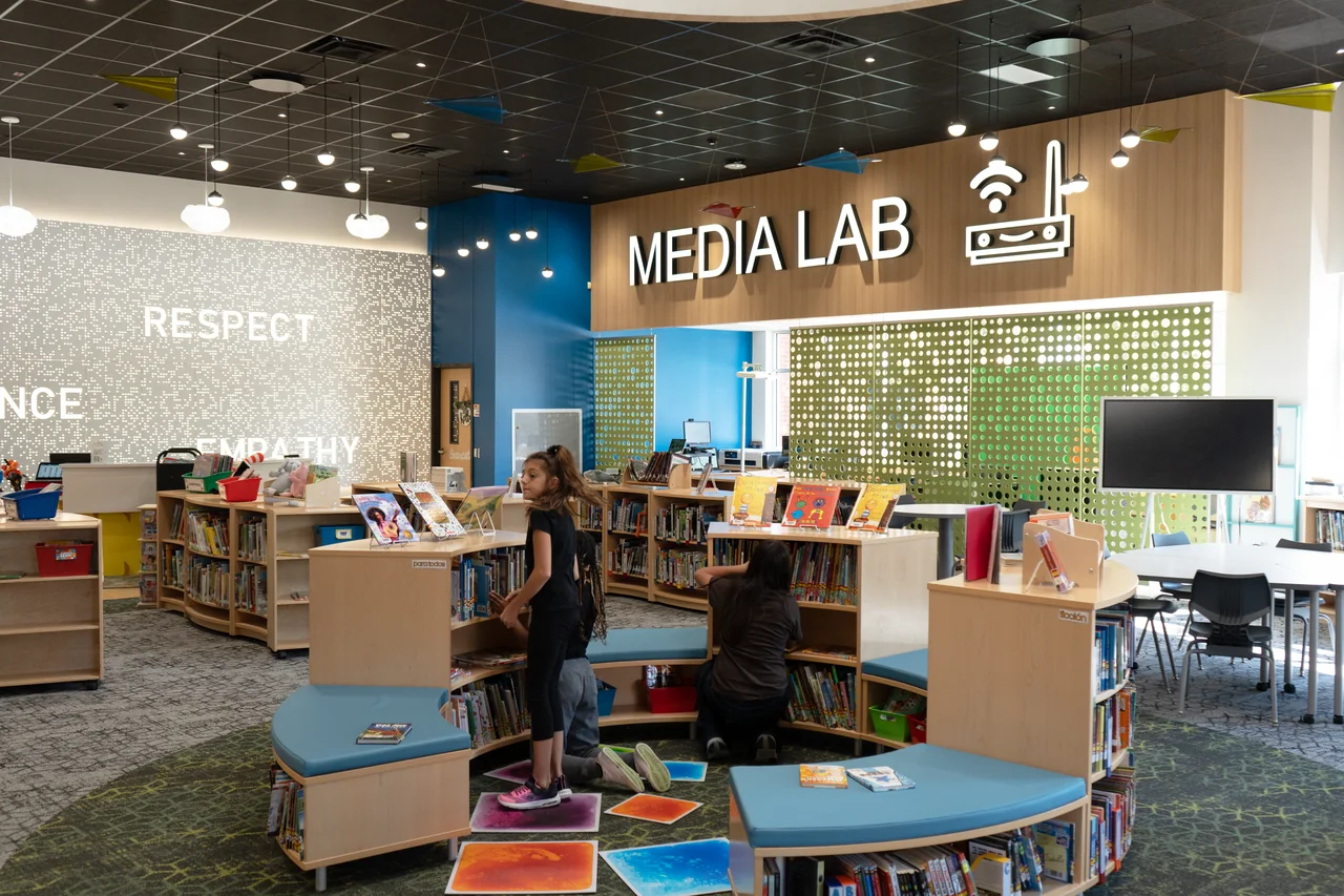 Students work at computers below large Media Lab lettering.