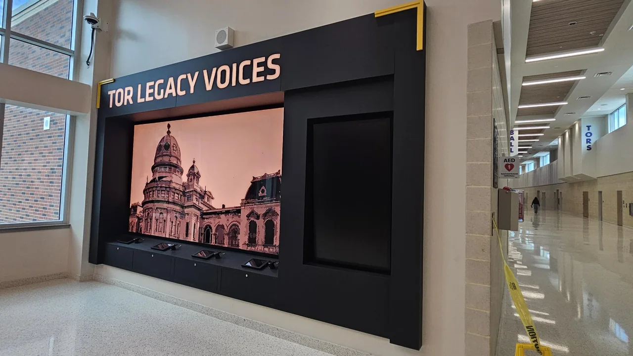 A large screen fills the Tor Legacy Voices exhibit wall.